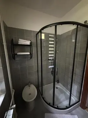 a bathroom with a shower and a toilet at Guest House Kmečki Hram FORTUNA in Idrija