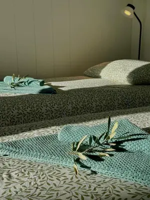 a row of three beds with towels on them at Studio Apartma Olive, Nova Gorica, Slovenia in Nova Gorica