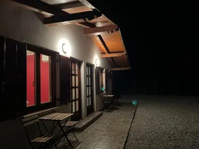 an empty room with tables and chairs in the dark at Studio Apartma Olive, Nova Gorica, Slovenia in Nova Gorica