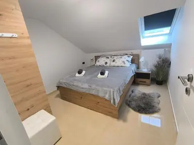 a bedroom with a bed with two shoes on it at JO-MA apartma - FREE parking in Ljubljana