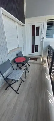 a patio with a table and chairs on a porch at JO-MA apartma - FREE parking in Ljubljana