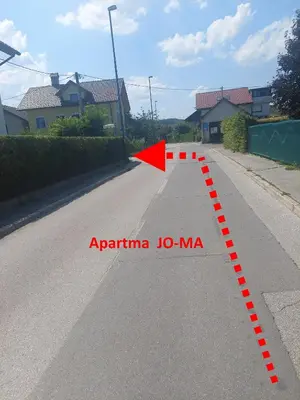 a street with a red arrow on the road at JO-MA apartma - FREE parking in Ljubljana