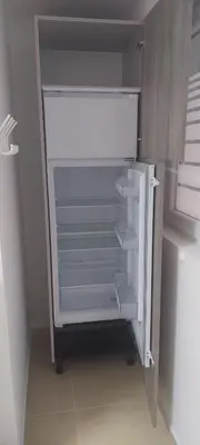 an empty refrigerator with its door open in a kitchen at JO-MA apartma - FREE parking in Ljubljana