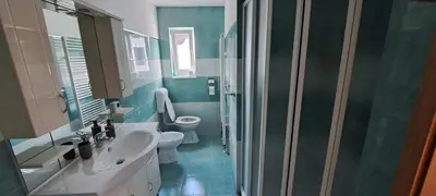 a bathroom with two toilets and a sink and a shower at Apartma Bine in Bled