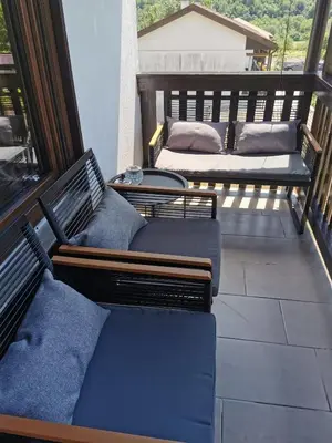 a balcony with two benches and two beds on it at Apartma Bella Nadiža in Kobarid