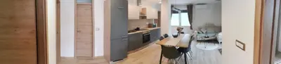 a kitchen with a counter and a table in it at Apartma Bella Nadiža in Kobarid