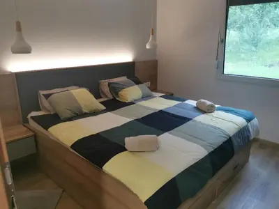 a large bed in a bedroom with two pillows at Apartma Bella Nadiža in Kobarid