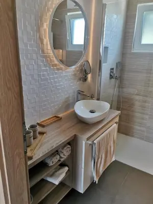a bathroom with a sink and a mirror at Apartma Bella Nadiža in Kobarid