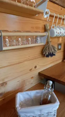 a bottle in a container on the floor in a kitchen at Pig barn - Svinjaki in Krasinec