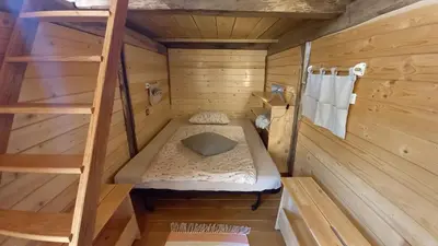 a small room with a bunk bed and a ladder at Pig barn - Svinjaki in Krasinec
