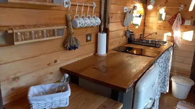a kitchen with a wooden counter in a tiny house at Pig barn - Svinjaki in Krasinec