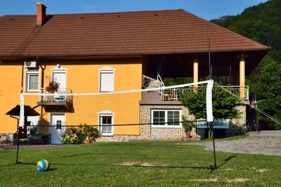 a house with a soccer ball in front at Apartment Sotočje in Dolenja Trebuša