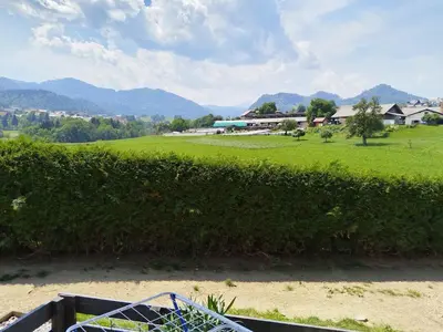 a view of a green field and mountains at Apartma Julia in Spodnje Gorje