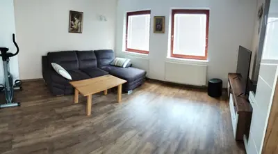 a living room with a couch and a table at Apartma Julia in Spodnje Gorje
