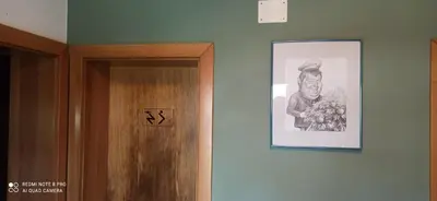 a picture of a man on a wall next to a door at Na vrtu K25 in Gradac