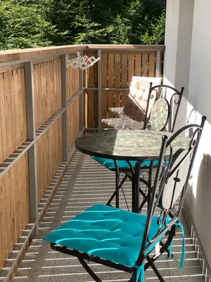 a patio with a table and a chair at Luxury Apart near Lake Bohinj in Bohinj