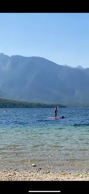 a person on a paddle board in the water at Luxury Apart near Lake Bohinj in Bohinj