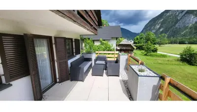 a balcony with furniture and a view of a mountain at Počitniška hiša pr Puc in Mojstrana