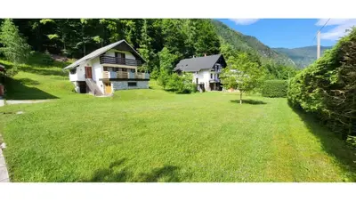 a house with a large yard in front of a house at Počitniška hiša pr Puc in Mojstrana