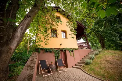 a house with two chairs in front of it at Počitniška hiša Car in Dobrovnik