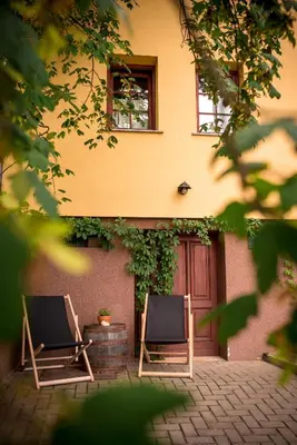 two chairs sitting in front of a building at Počitniška hiša Car in Dobrovnik
