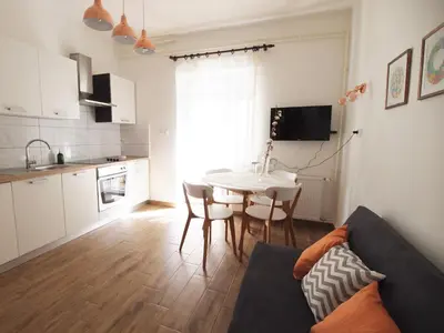 a living room with a couch and a table and a kitchen at In the Center of Rogaška Slatina! Apartment Fani and Studio Marija in Rogaška Slatina