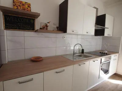 a kitchen with white cabinets and a sink at In the Center of Rogaška Slatina! Apartment Fani and Studio Marija in Rogaška Slatina