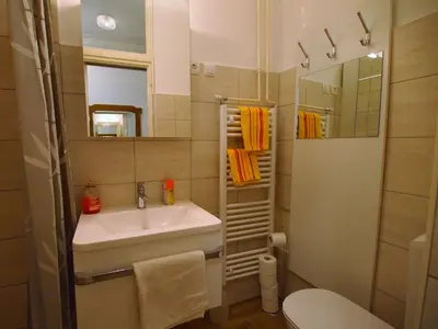 a bathroom with a sink and a toilet and a mirror at In the Center of Rogaška Slatina! Apartment Fani and Studio Marija in Rogaška Slatina