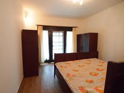 a bedroom with a bed and a window at In the Center of Rogaška Slatina! Apartment Fani and Studio Marija in Rogaška Slatina