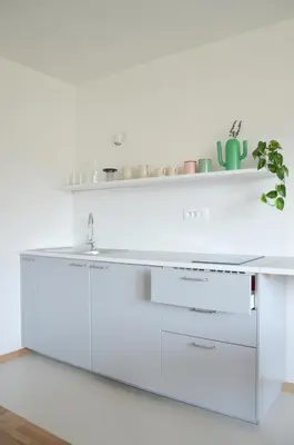 a kitchen with a white counter and a sink at STUDIO GREENHOUSE in Tolmin