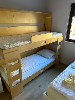 a couple of bunk beds in a room at BovecEnter Apartments Kaninska vas in Bovec