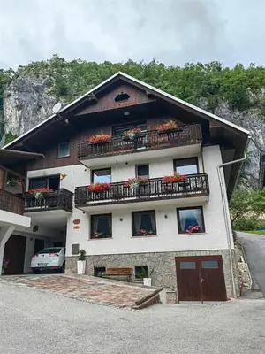 a building with flowers on the balconies of it at Apartma Bela in Bohinjska Bela