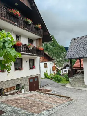 a building with flower boxes on the balconies of it at Apartma Bela in Bohinjska Bela