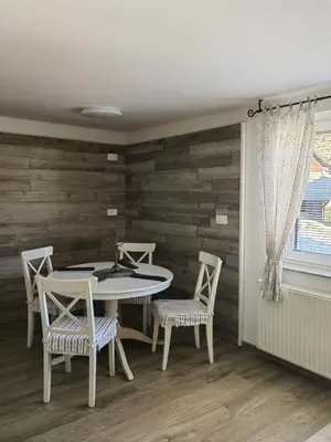 a dining room with a table and chairs at Apartma Bela in Bohinjska Bela