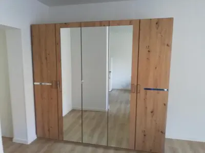 a large glass door in a room with wooden walls at Maestro I. in Laško