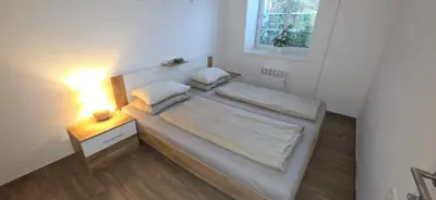 a small bedroom with a bed and a night stand at Maestro I. in Laško