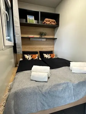 a bedroom with a bed with two pillows on it at KOLPA - Luxury Natura House in Gradac