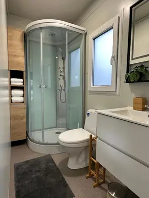 a bathroom with a shower and a toilet and a sink at KOLPA - Luxury Natura House in Gradac