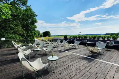 a bunch of chairs and tables on a deck at KOLPA - Luxury Natura House in Gradac