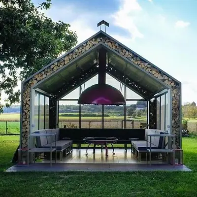a gazebo with a table and chairs and an umbrella at KOLPA - Luxury Natura House in Gradac