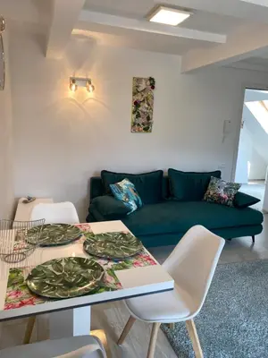 a living room with a green couch and a table at Mountain view in Bohinj in Bohinj