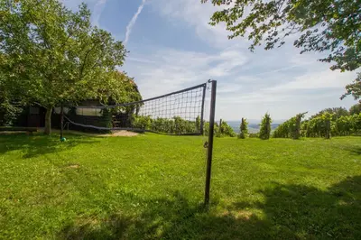 a volleyball net in a grassy field at Holiday Home Juričko with private Sauna in Bizeljsko