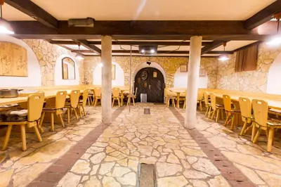 a large room with tables and chairs and a door at Holiday Home Juričko with private Sauna in Bizeljsko