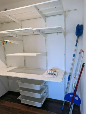 a room with a closet with shelves and tools at Domen's cozy rentals in Kranj