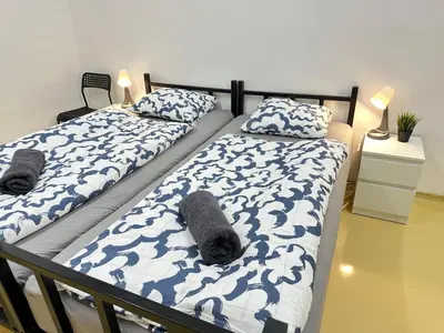 two beds in a bedroom with towels on them at Railway Ljubljana ROOMS in Ljubljana