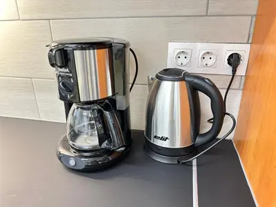 a coffeemaker and a coffee maker on a counter at Railway Ljubljana ROOMS in Ljubljana