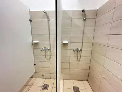 a shower with a glass door in a bathroom at Railway Ljubljana ROOMS in Ljubljana