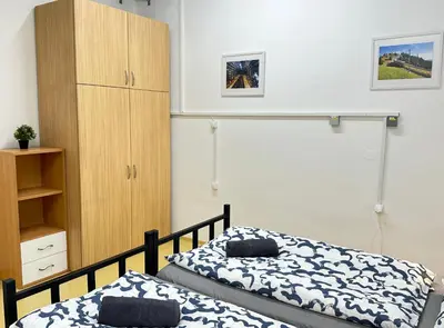 a bedroom with a bed and a cabinet at Railway Ljubljana ROOMS in Ljubljana