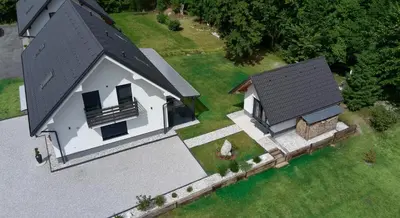 an overhead view of a white house with a black roof at Riverside Apartma 1, Kranjska Gora in Kranjska Gora