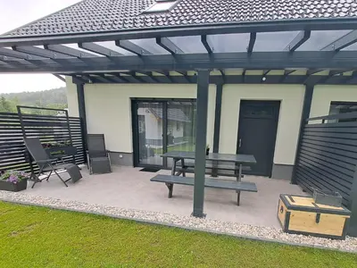 a pavilion with a picnic bench and a table at Riverside Apartma 1, Kranjska Gora in Kranjska Gora